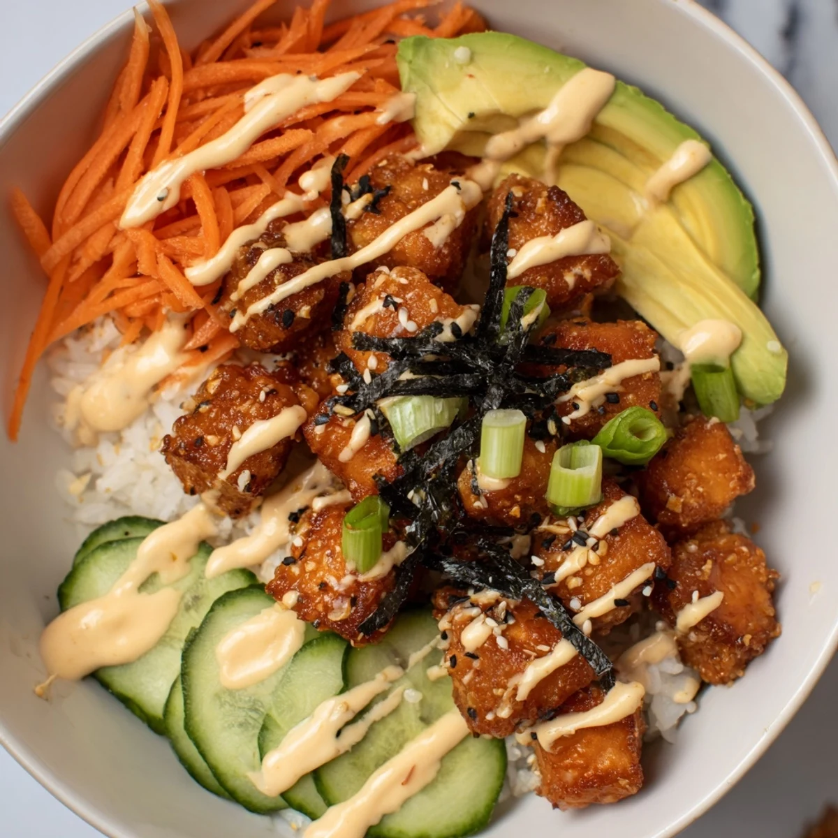 Golden, crispy salmon bites in a bowl, a delicious fusion recipe with fresh veggies.