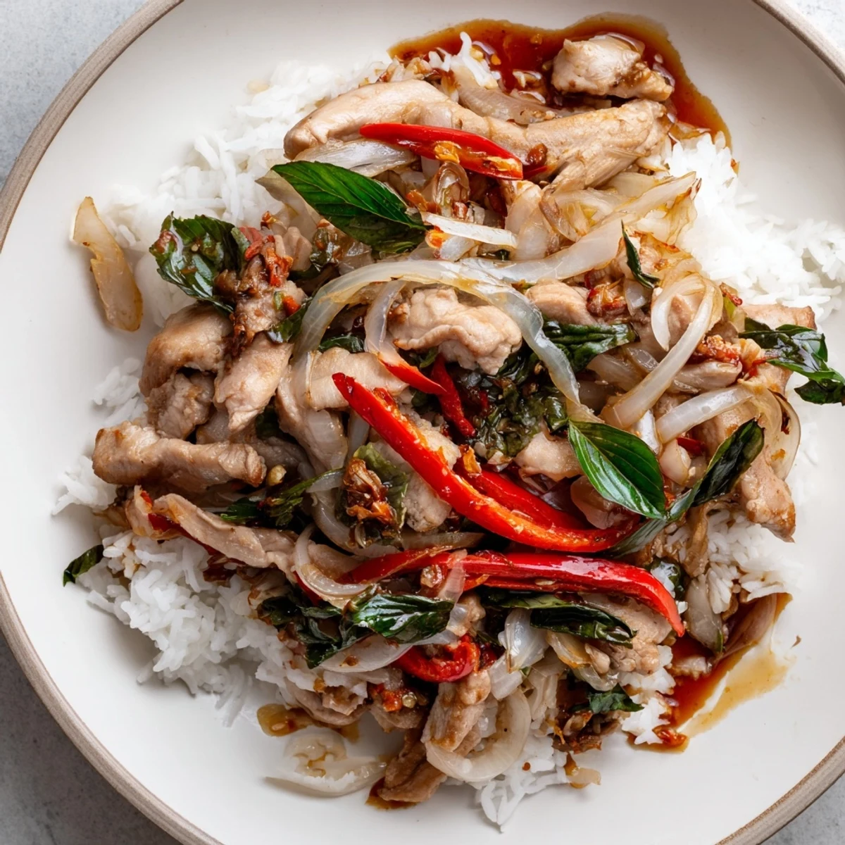 Steaming Thai Basil Chicken Bowls with fragrant basil, colorful bell peppers, and savory sauce.