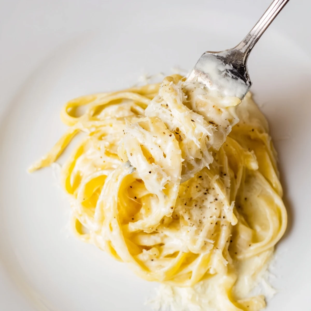 Creamy roasted garlic pasta with golden roasted garlic cloves, silky cream sauce, and freshly grated Parmesan garnished with parsley.