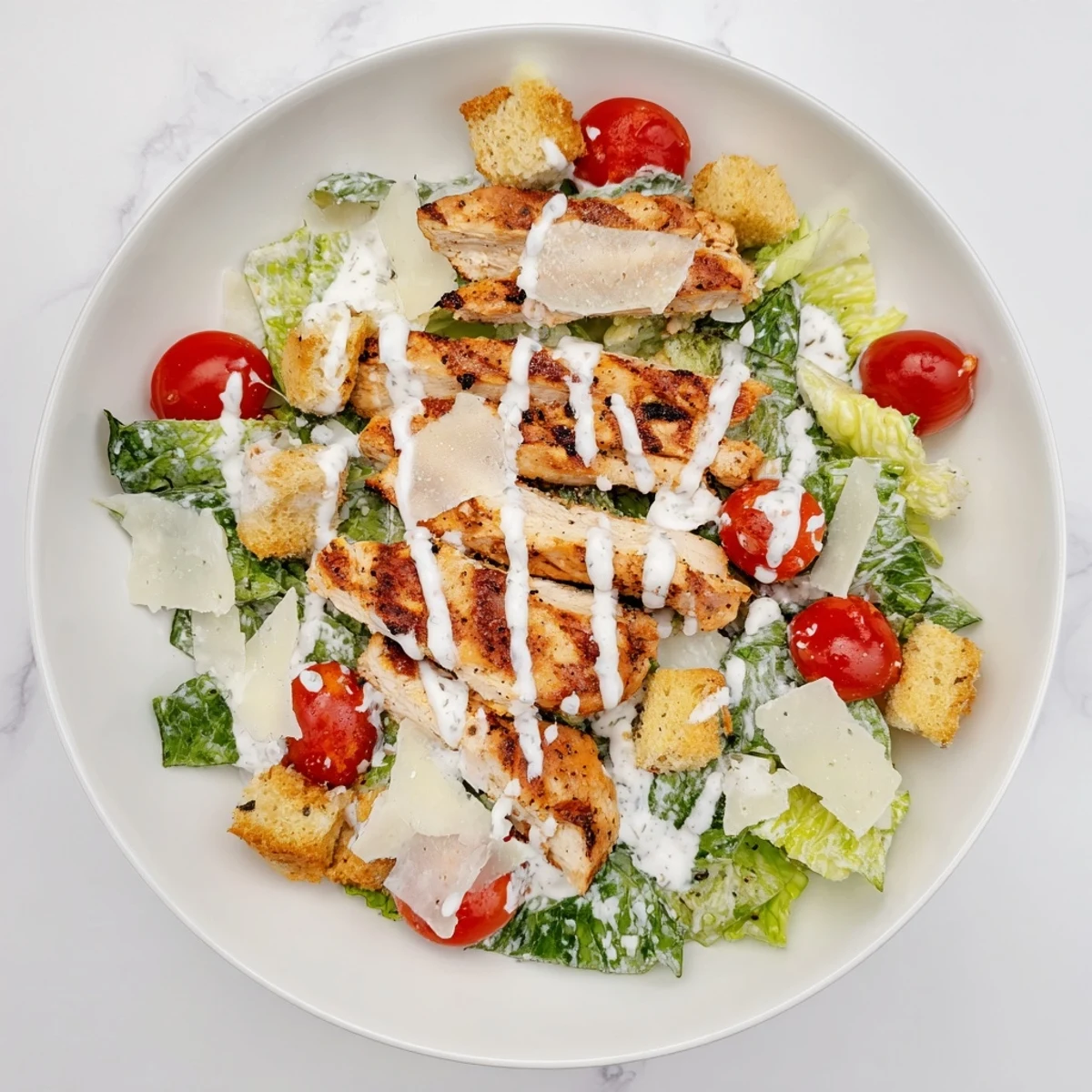 Homemade croutons and shaved Parmesan garnish this vibrant Yogurt Caesar Grilled Chicken Salad, served on a rustic wooden table.