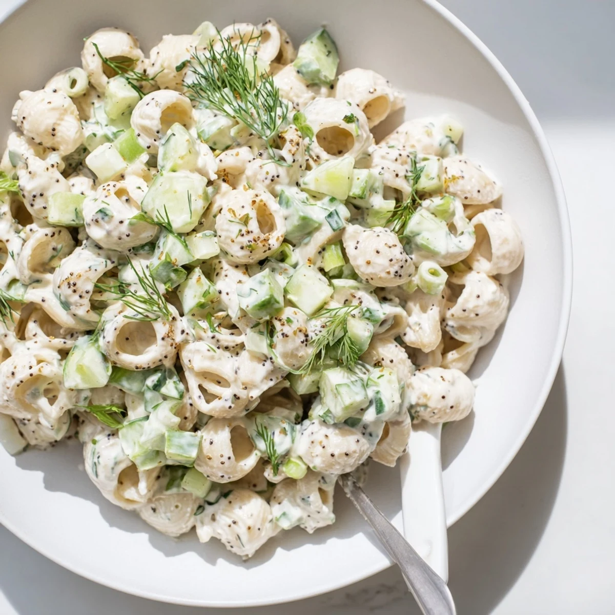 Creamy Cucumber Crunch Pasta Salad with dill and everything bagel seasoning, served chilled in a bowl for summer picnics.