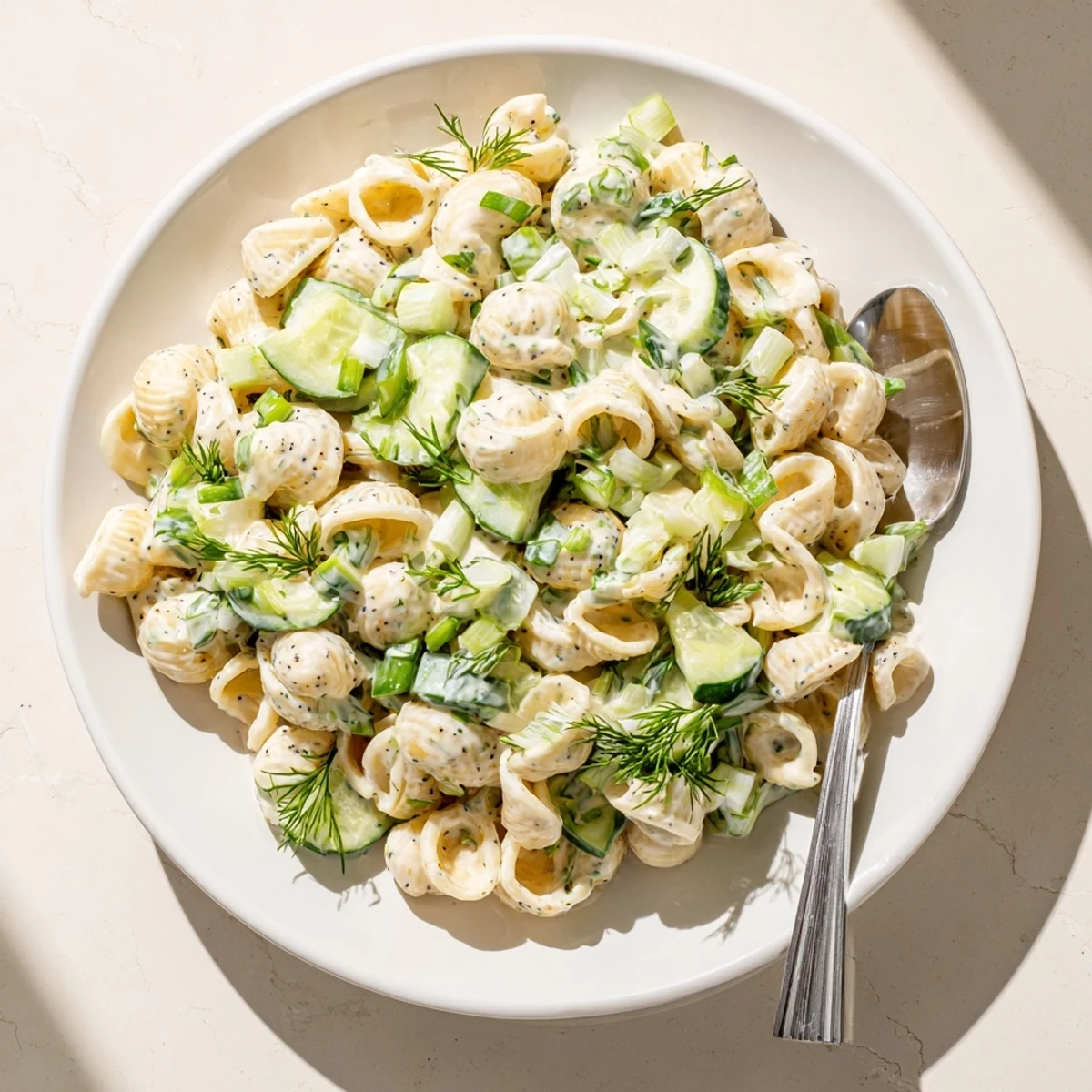 Vegetarian Cucumber Crunch Pasta Salad ready to serve, dotted with everything bagel seasoning for extra savory crunch.
