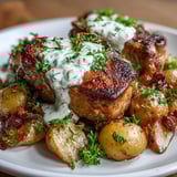 Slow-cooker Crockpot Ranch Pork Chops served over mashed potatoes with fresh parsley garnish.