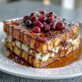 Warm Blueberry Pancake Casserole with tender baked layers, fresh berries, and a light dusting of powdered sugar, ready for serving.  