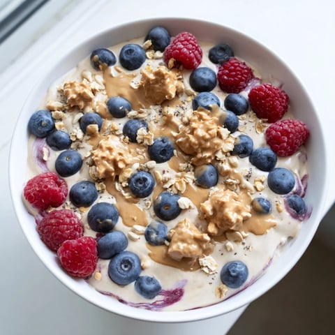 A vibrant Protein Ice Cream Bowl with fresh berries, offering a cool, healthy dessert choice.