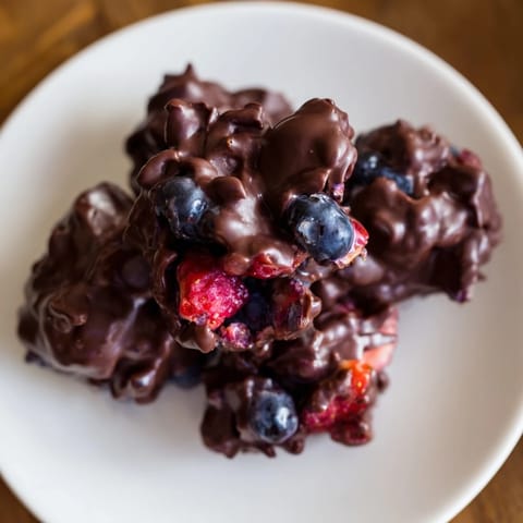 Frozen Chocolate Yogurt Clusters ready to delight, with a colorful burst of fresh berries, a healthy treat.