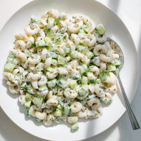 Cold small shell pasta tossed with crisp diced cucumbers, green onions, and fresh dill in tangy dressing.