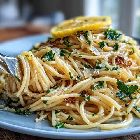 Creamy lemon butter pasta with bright citrus zest, silky Parmesan sauce, and al dente spaghetti in a cozy bowl.  