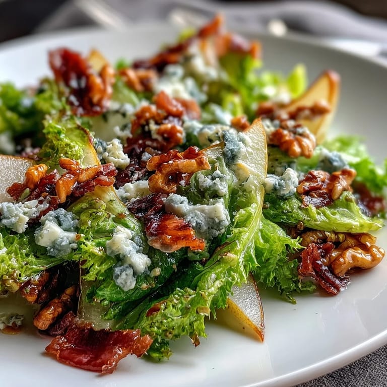 A refreshing Frisée Pear Blue Cheese Bowl tossed with walnuts and a zesty vinaigrette, ready to serve.