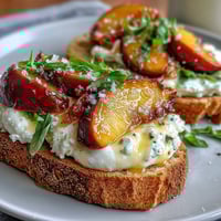 Creamy burrata, sweet peaches, and golden honey atop rustic sourdough toast—perfect for a spring brunch.
